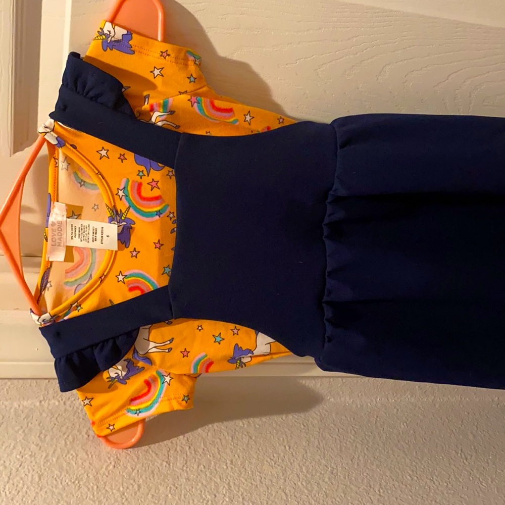 I am selling an orange shirt with unicorns/rainbows. Navy dress.